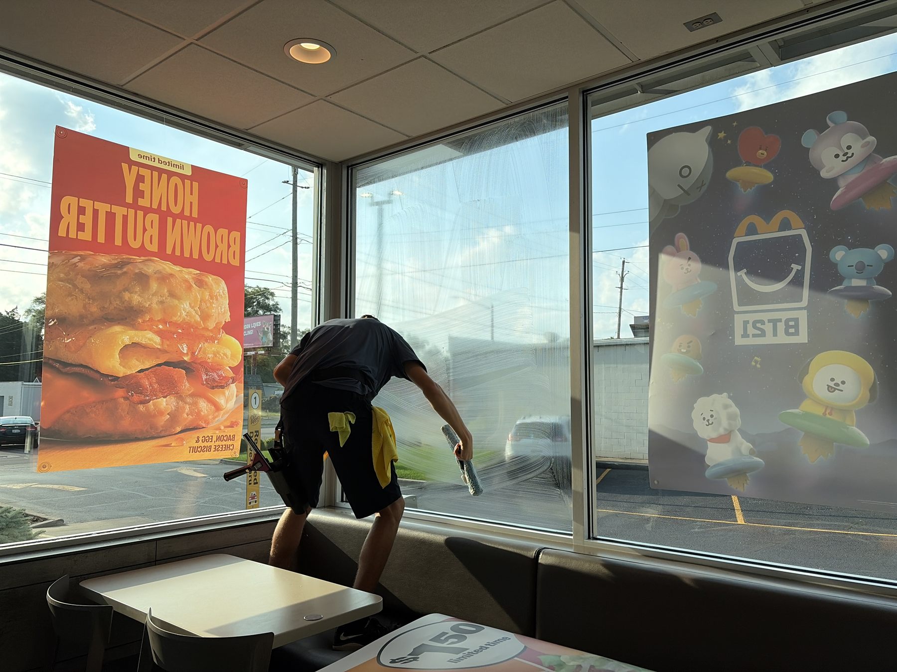 Cleaning the interior of a restaurant dining room window